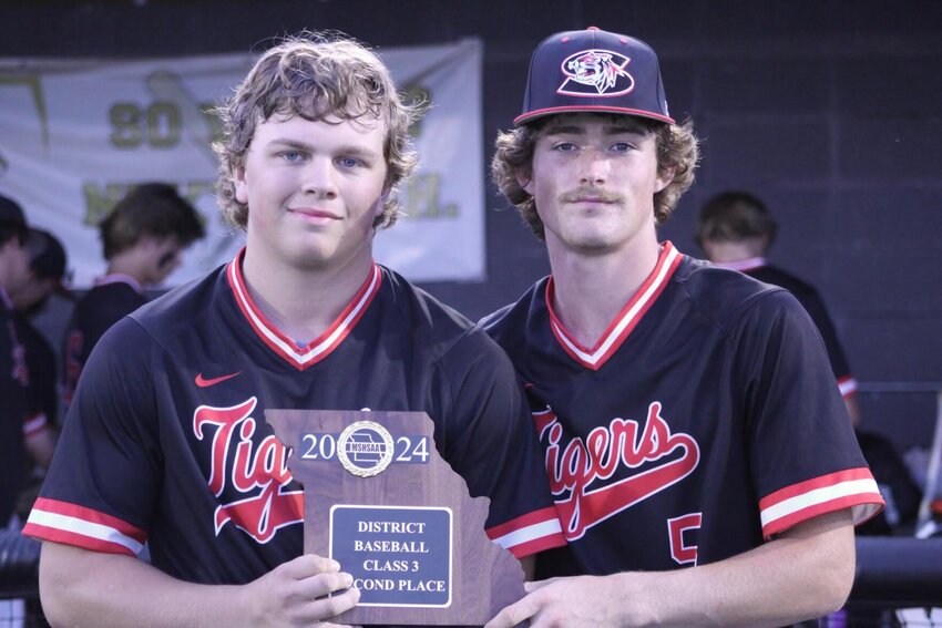 Seniors Kolten Goodman (left) and Sayge Painter show off their second place plaque after falling to Lamar in the district championship game last week