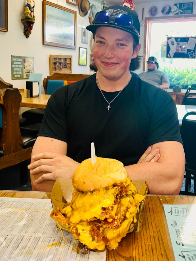 Austin Surber facing the giant eight patty Squeezeburger.