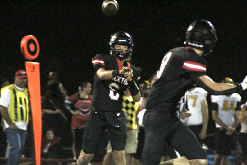 Quarterback Easton Hubbard swings a pass to Jack Rickman last Friday as the Tigers defeated Diamond, 50-8 on homecoming night.