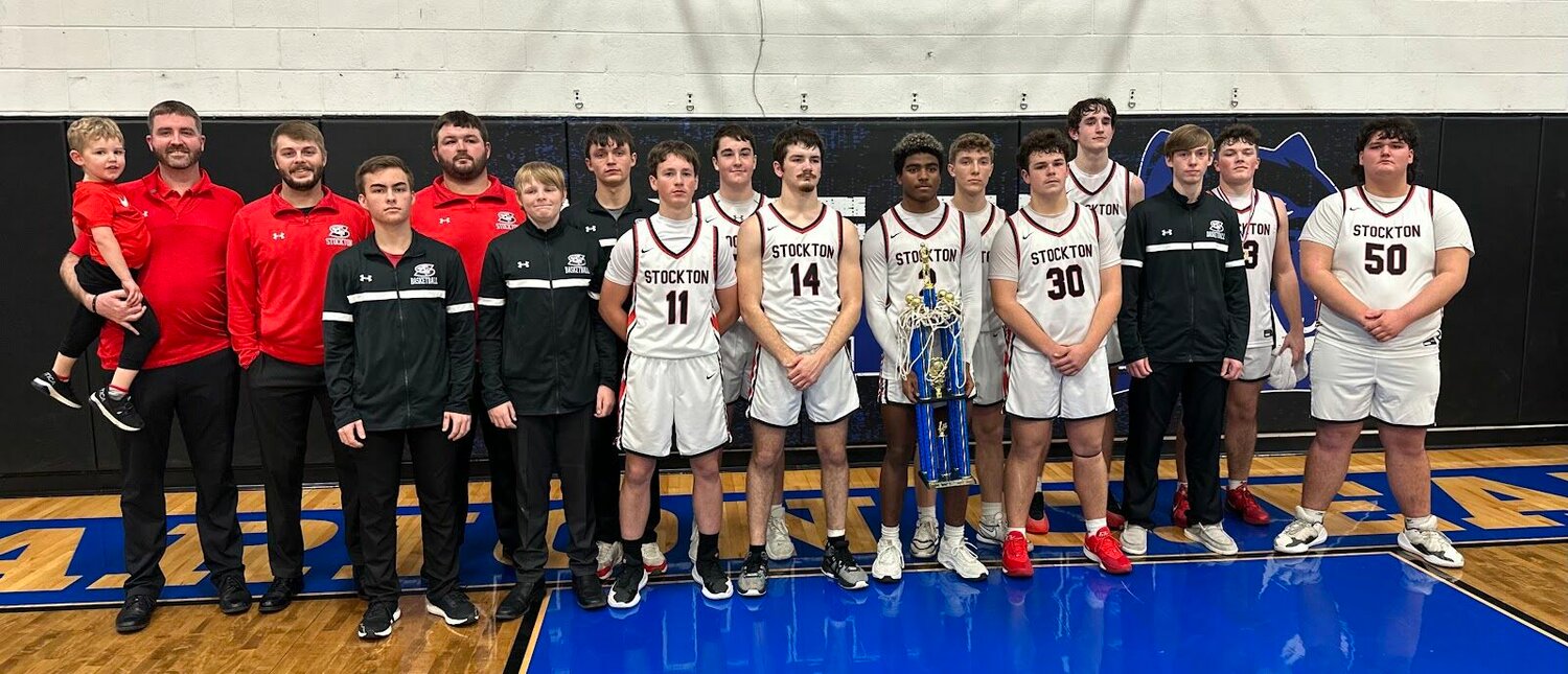 The Stockton Tigers show off their newest hardware after taking the championship of the 53rd Annual Morrisville Boys Basketball Tournament. (From left): Austin Boone, Head Coach Andrew Boone, Assistant Coach Ryan Pate, J.J. Anderson, Assistant Coach Gavin Kenney, Hunter Nolting, Weslee Hargus, Justus King, Cannon Brown, Logan Reser, Landon Sexton, Carter Thornton, J.D. Flora, Jax Baxter, Colter Woods, Preston Rains, and Kale Rader.